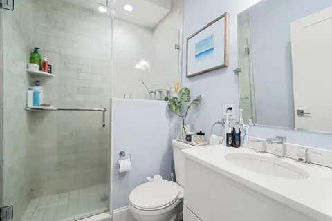 a bathroom with a sink toilet and shower