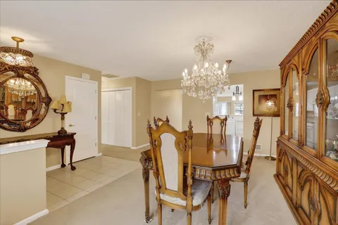 a view of a dining room with furniture and a chandelier