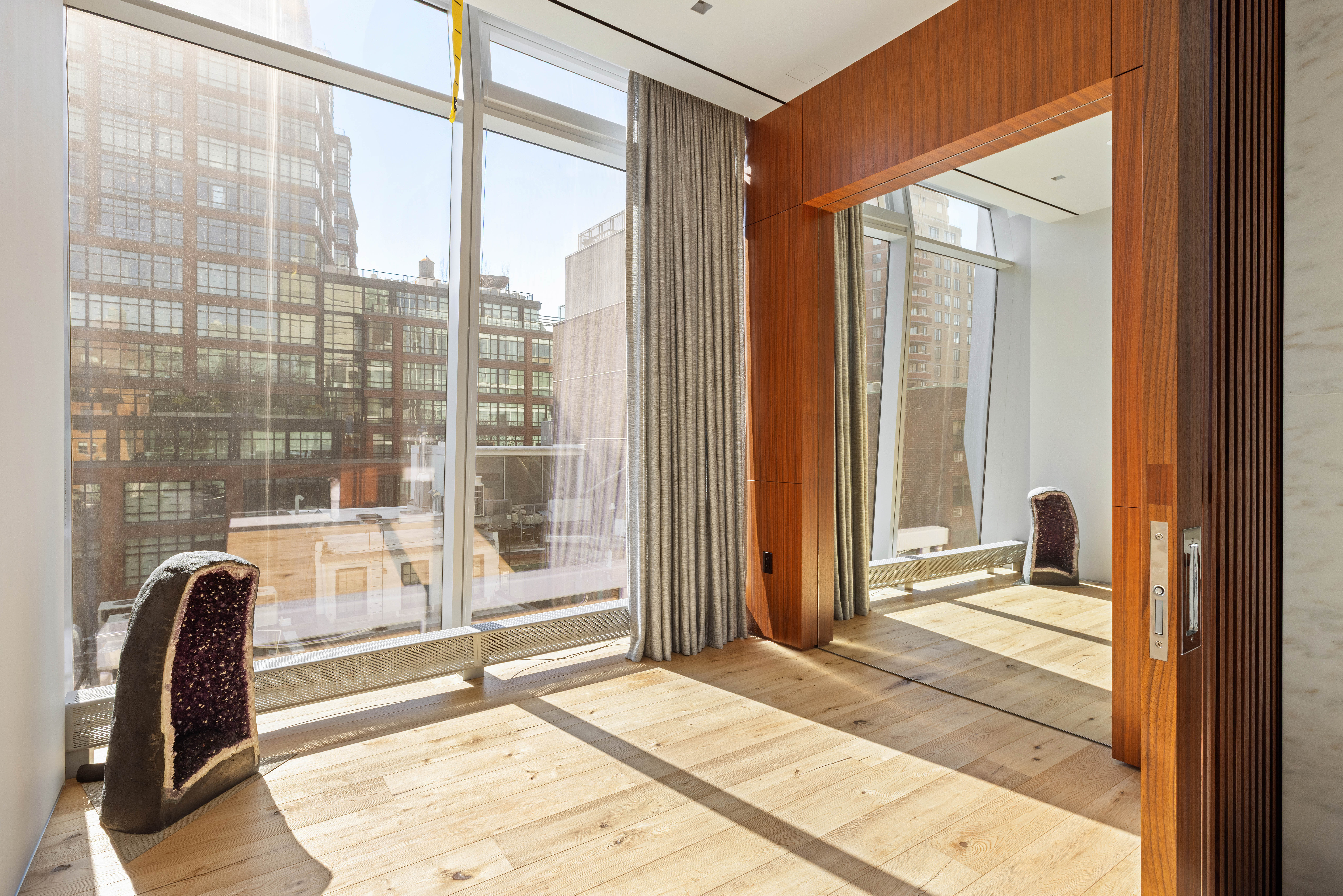 166 Perry Street, Unit 5A Manhattan, NY 10014 - Photo 13 of 25 a view of a glass door with a chair and a window