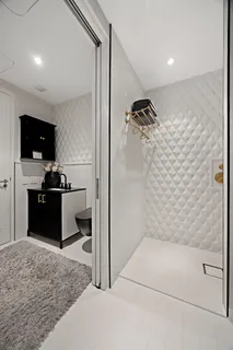 a walk in closet and view of bathroom