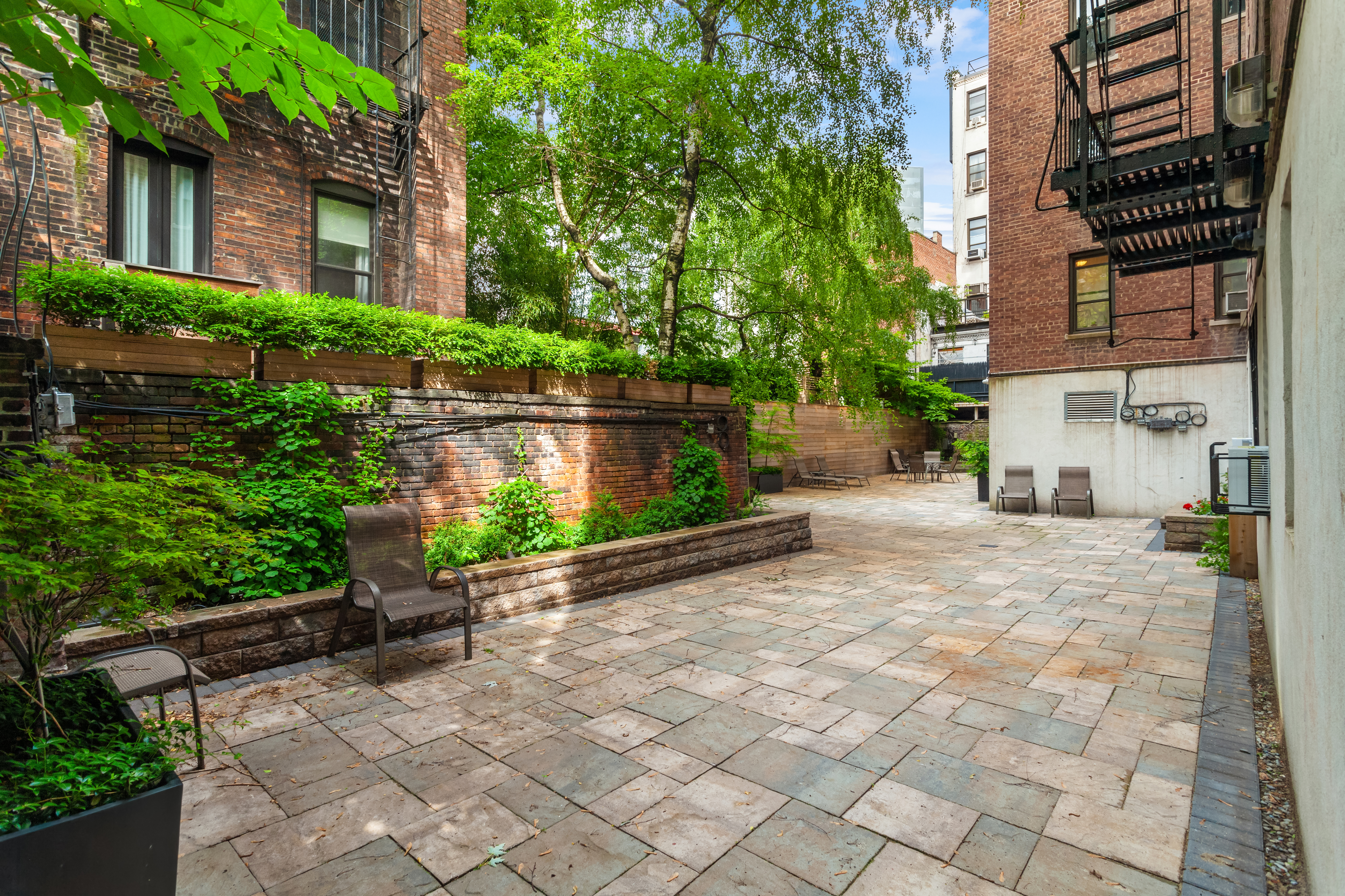 305 West 18th Street, Unit 4C Manhattan, NY 10011 - Photo 5 of 7 a view of building with yard