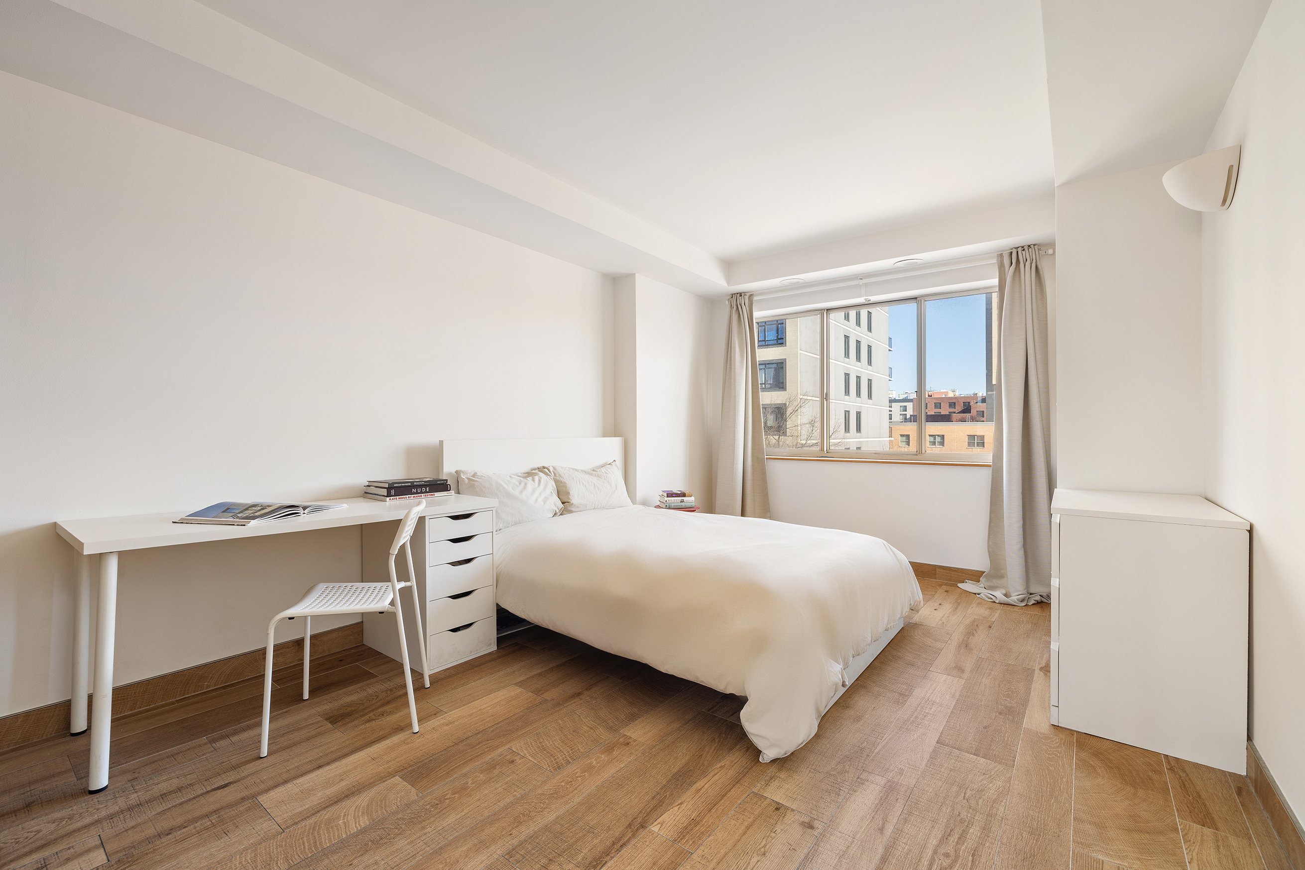 1400 5th Avenue, Unit 6P Manhattan, NY 10026 - Photo 6 of 8 a bedroom with a bed and a table in it