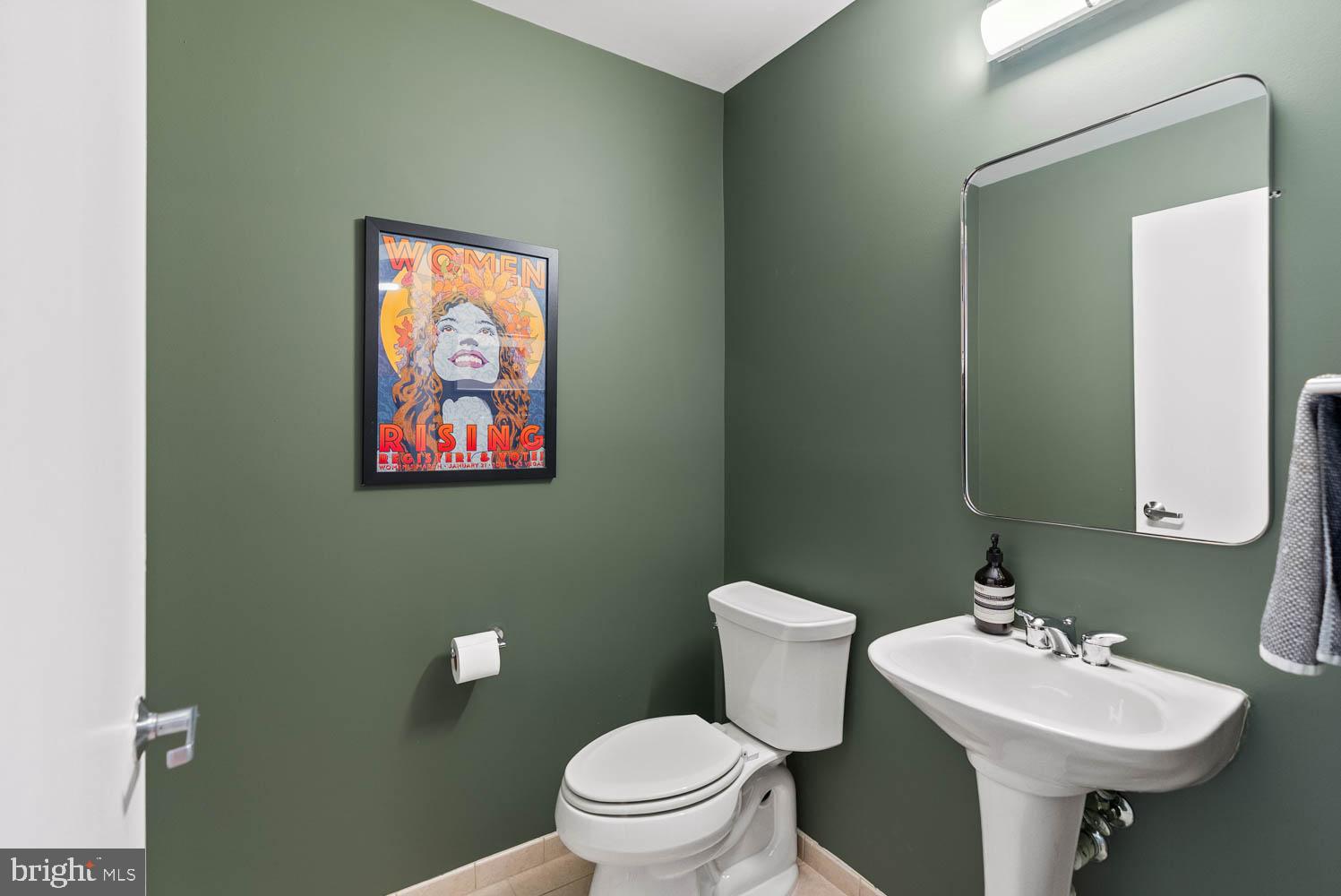 910 M Street Northwest, Unit 403 Washington, DC 20001 - Photo 15 of 31 a bathroom with a toilet sink and mirror