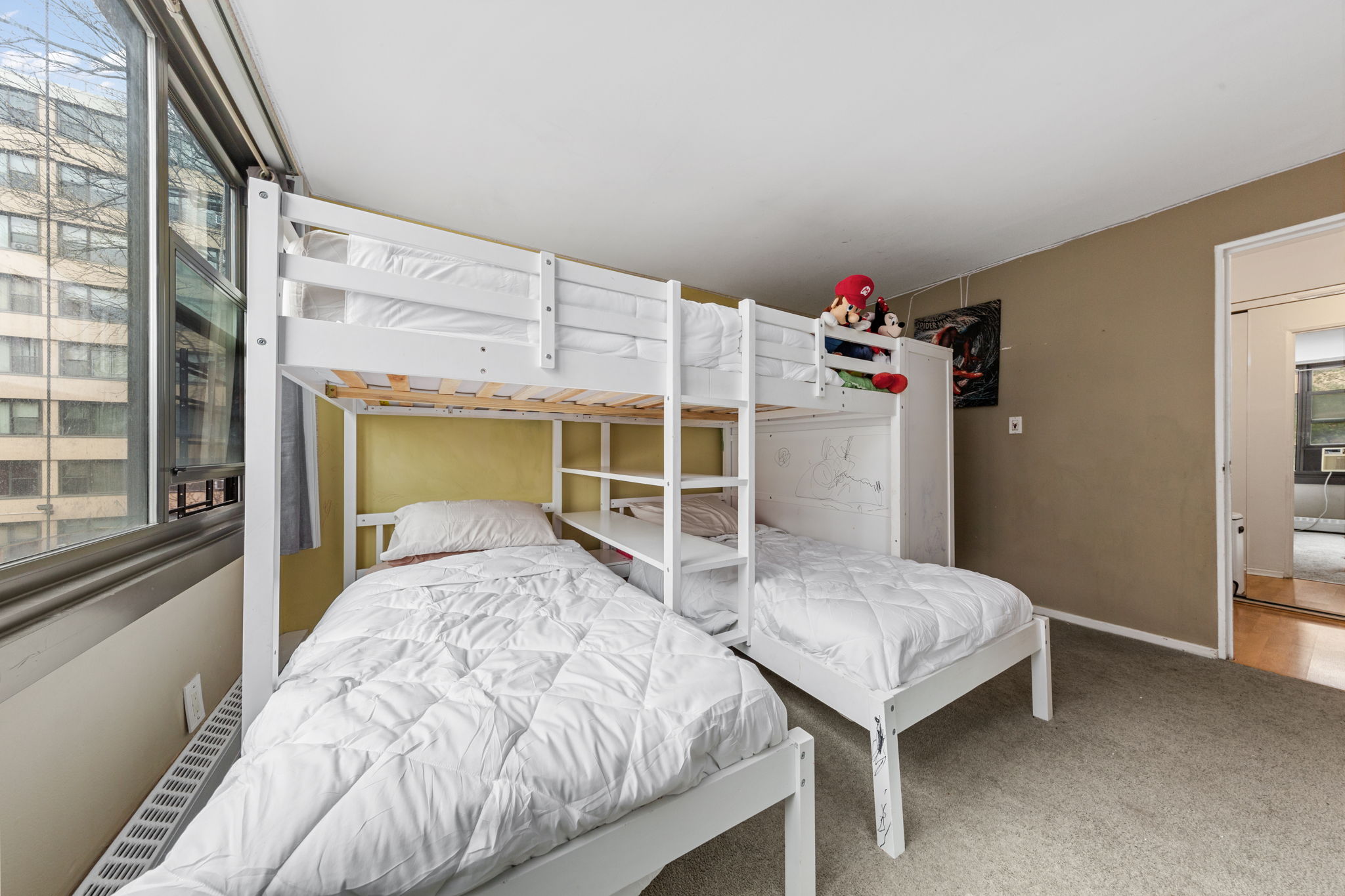 11-01 162nd Street, Unit 3D Queens, NY 11357 - Photo 8 of 16 a bedroom with a bed and a table