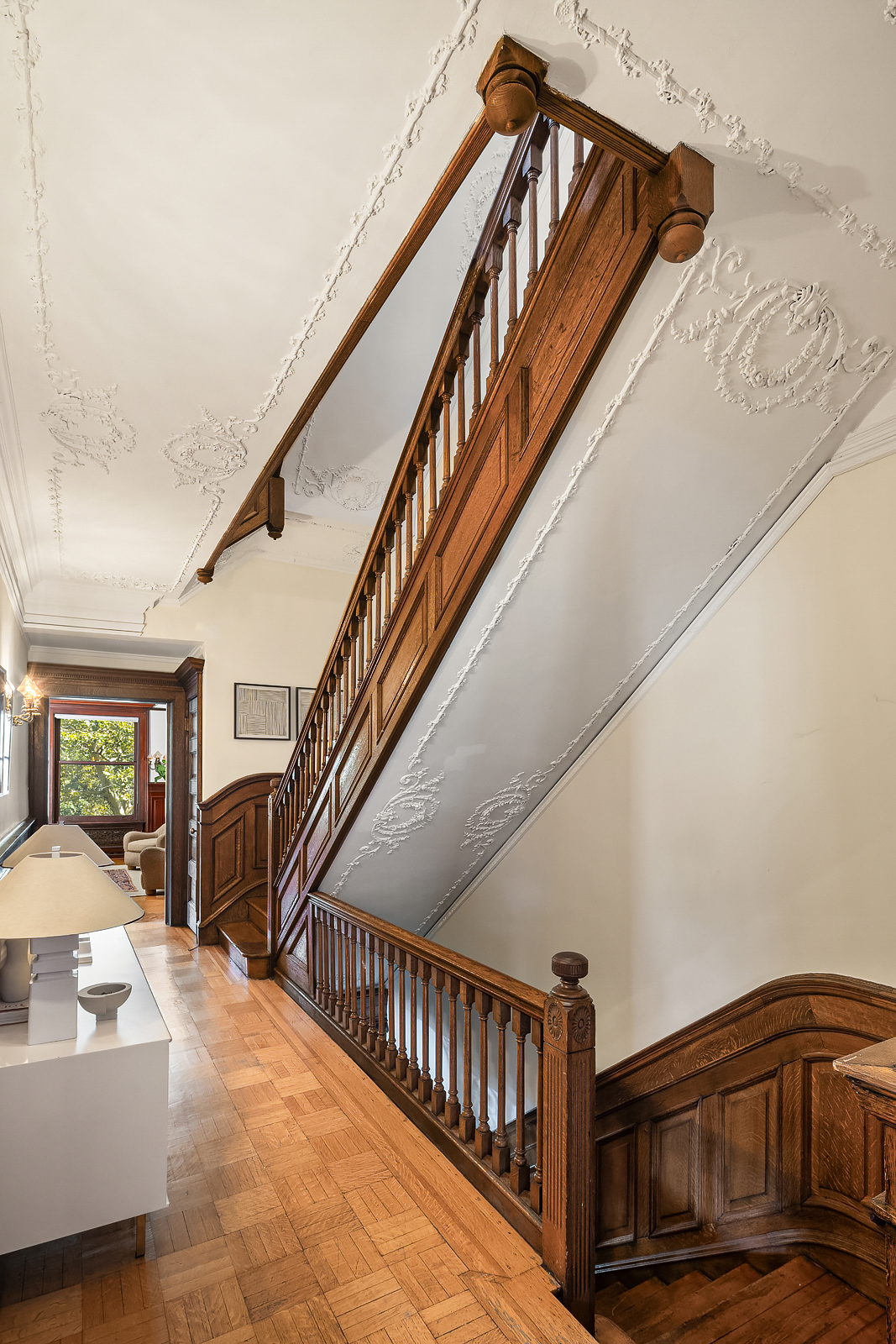 18 Prospect Park West Brooklyn, NY 11215 - Photo 24 of 40 a view of staircase with lots of frames on wall and wooden floor