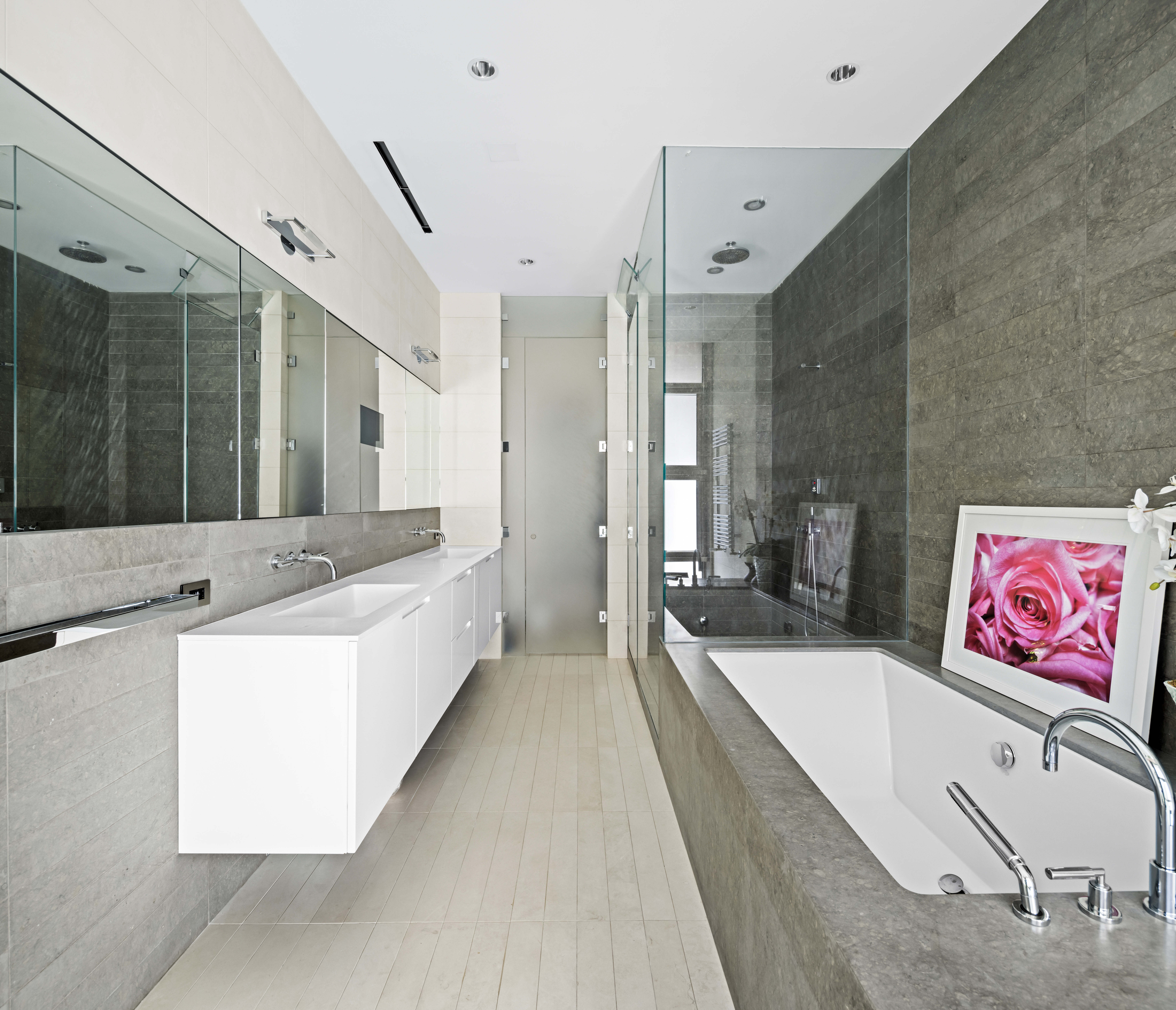 33 Vestry Street, Unit TH1 Manhattan, NY 10013 - Photo 12 of 17 a bathroom with a tub a double vanity sink and mirror