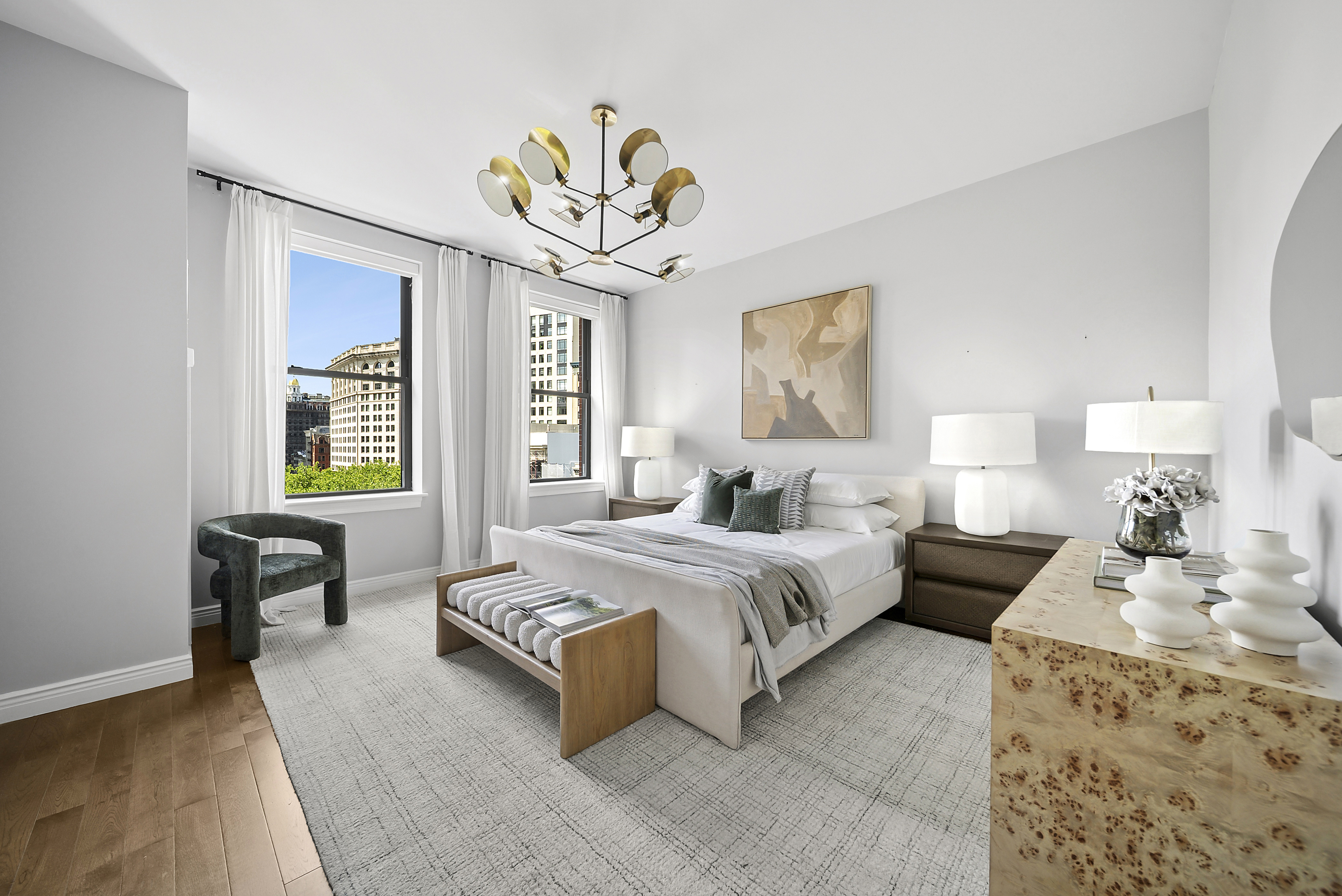 225 5th Avenue, Unit 7K Manhattan, NY 10010 - Photo 7 of 15 a spacious bedroom with a bed and a chandelier