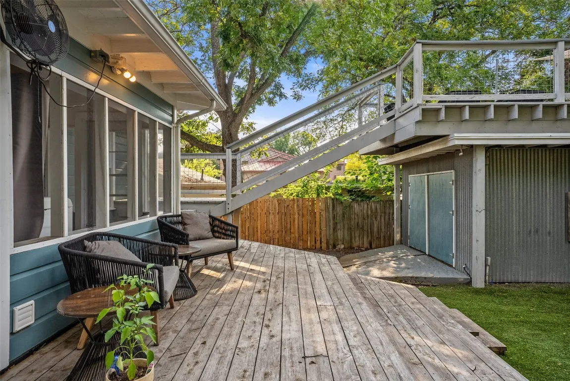 a view of balcony with wooden floor and outdoor seating