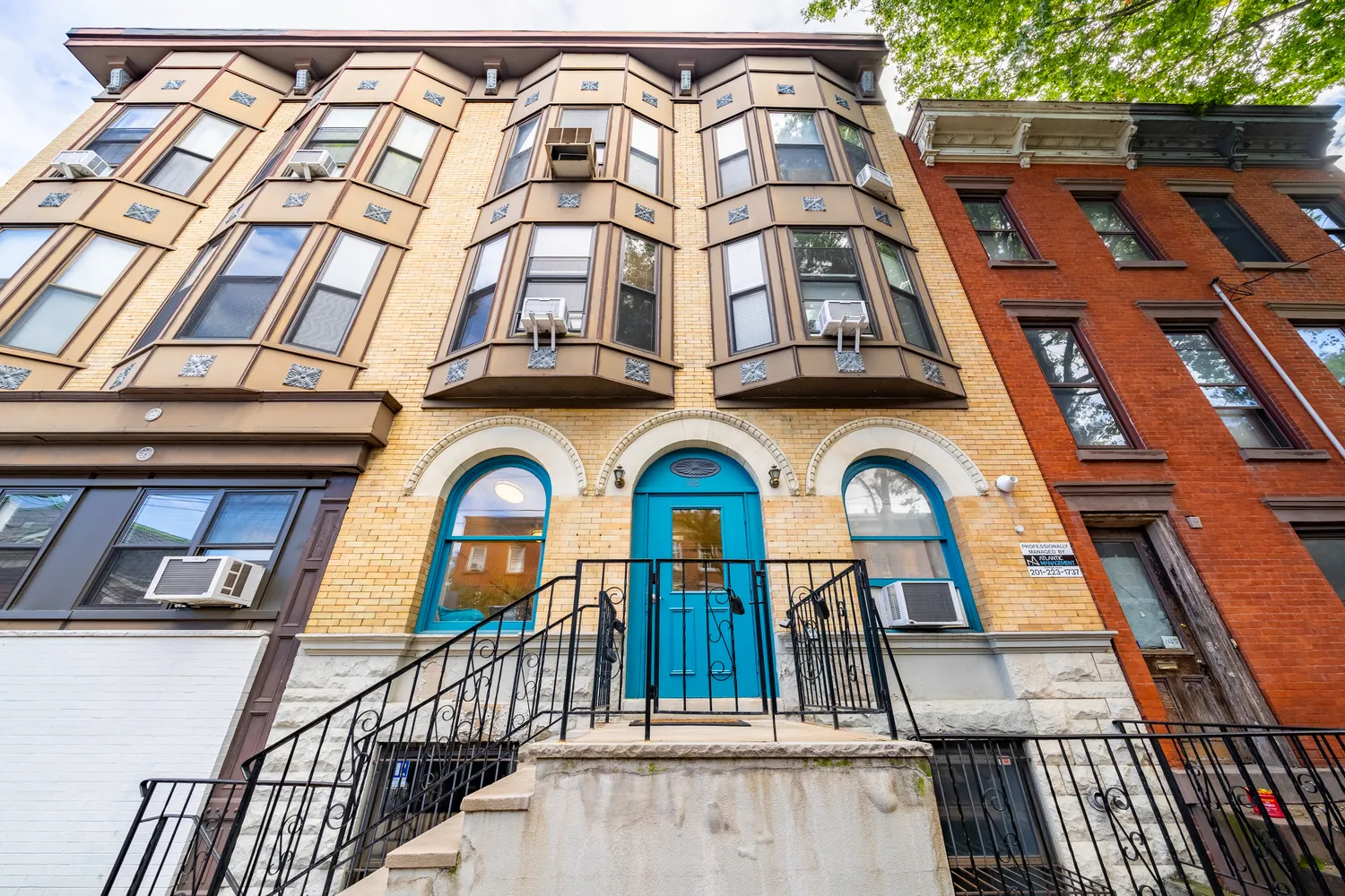 a view of a brick building with large windows