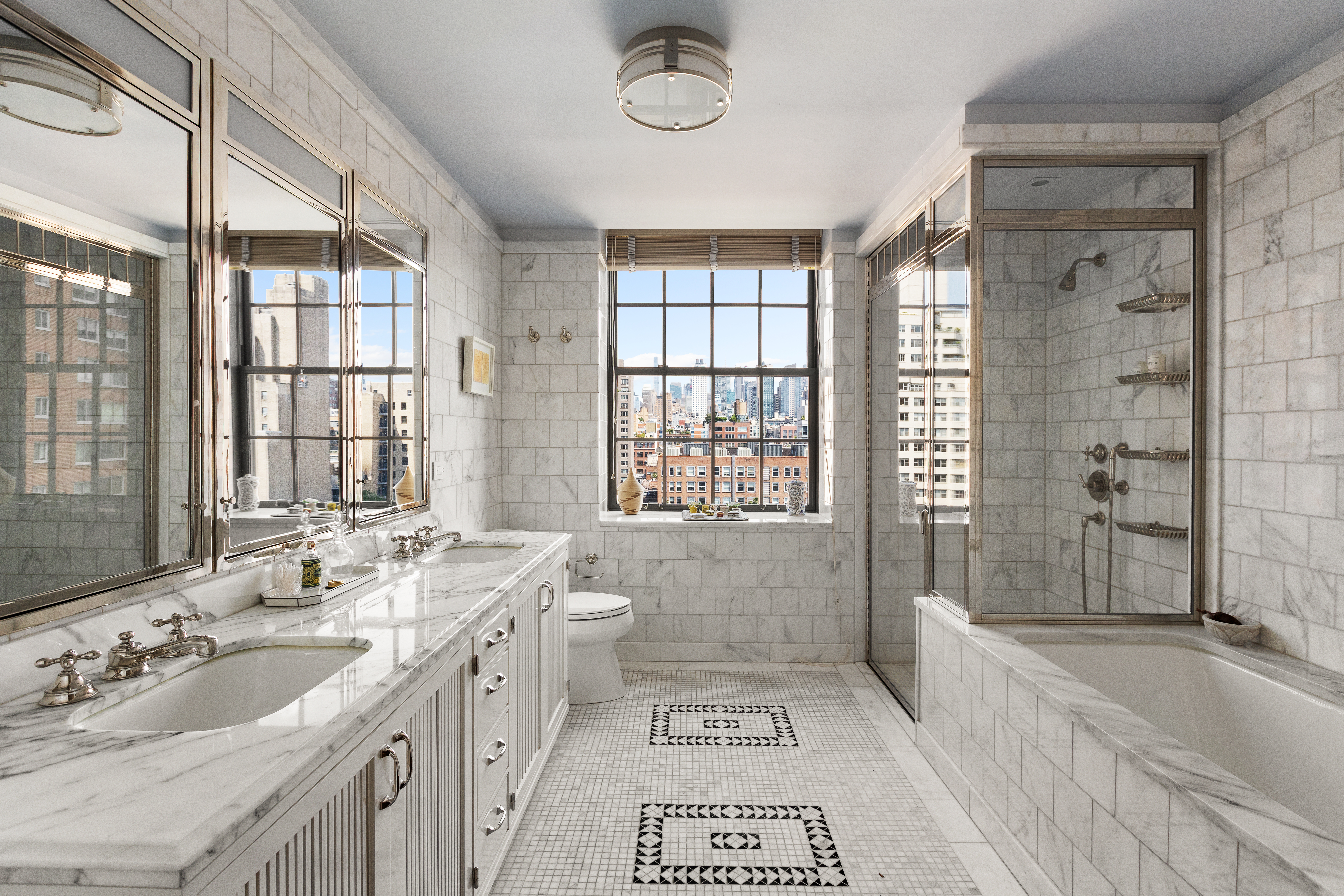 160 West 12th Street, Unit 104 Manhattan, NY 10011 - Photo 11 of 28 a spacious bathroom with double vanity sink a mirror a bathtub and next to a window