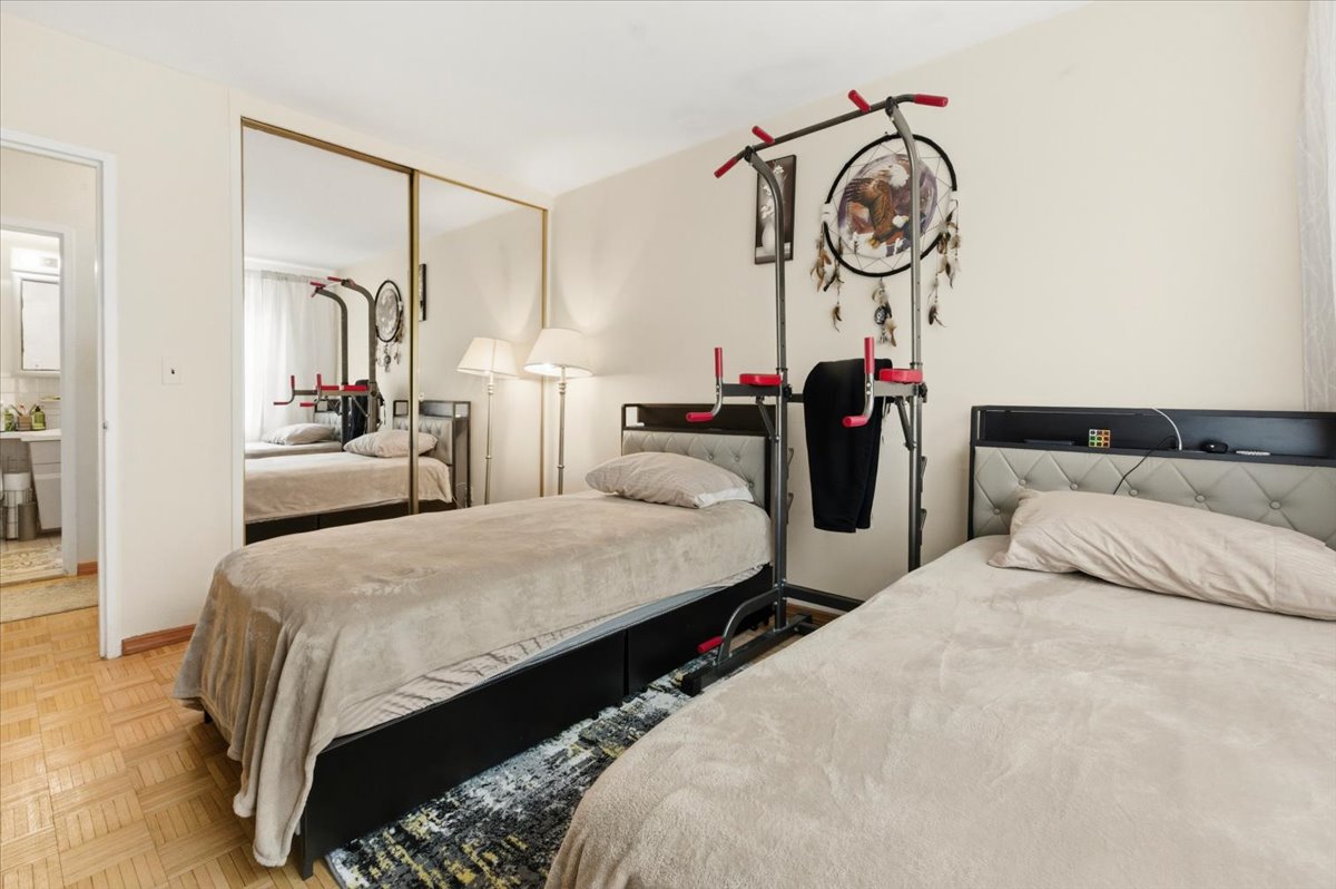 448 Neptune Avenue, Unit 14J Brooklyn, NY 11224 - Photo 6 of 21 a bedroom with bed and windows