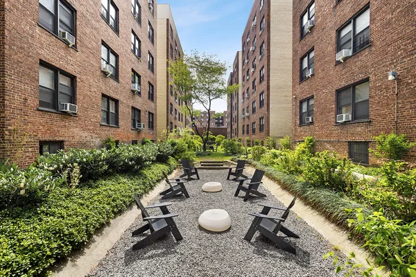 a view of a chairs in a patio next to a building