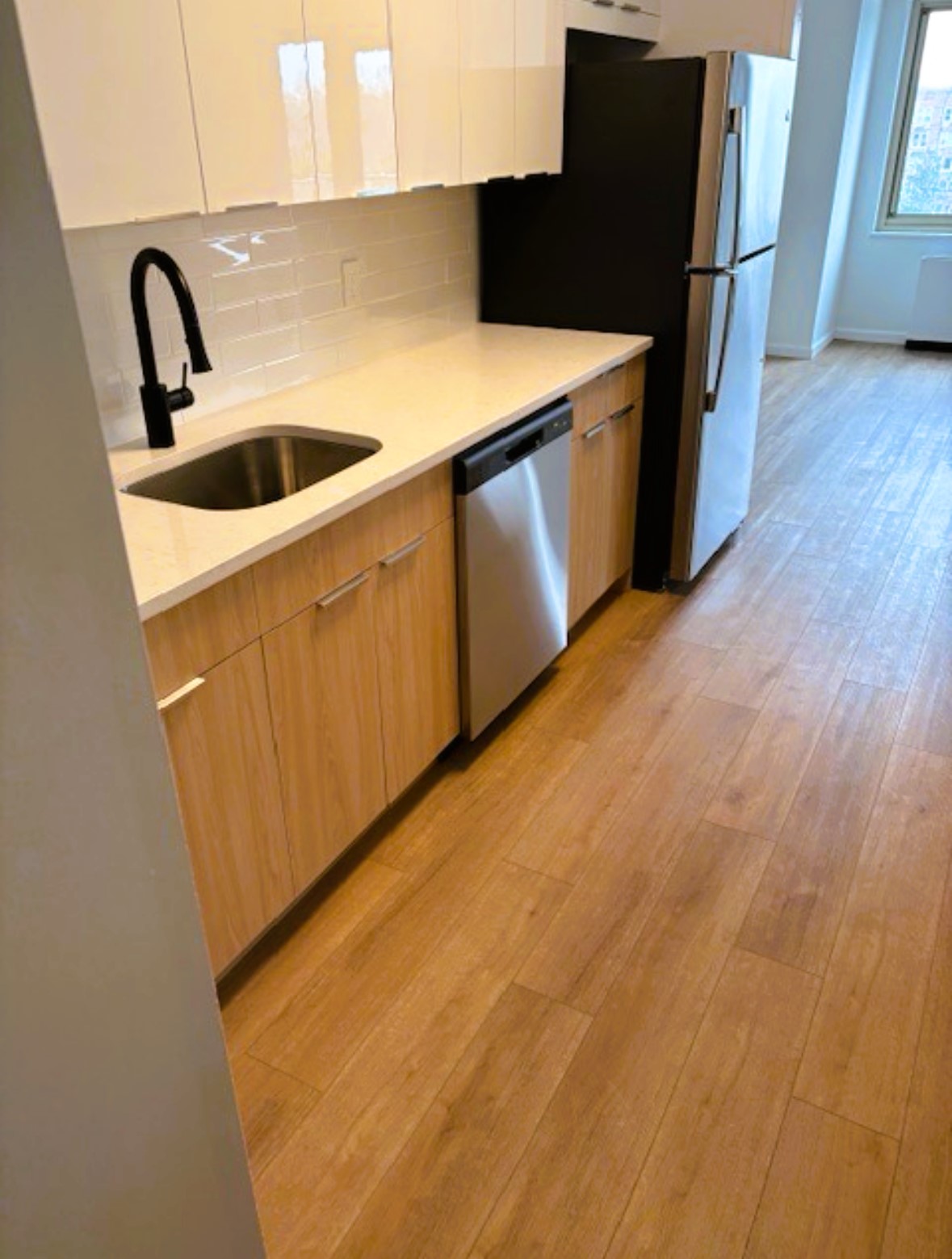 400 East 54th Street, Unit 19H Manhattan, NY 10022 - Photo 9 of 15 a kitchen with stainless steel appliances a sink a stove and a refrigerator