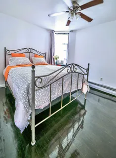 a bedroom with a bed and a window