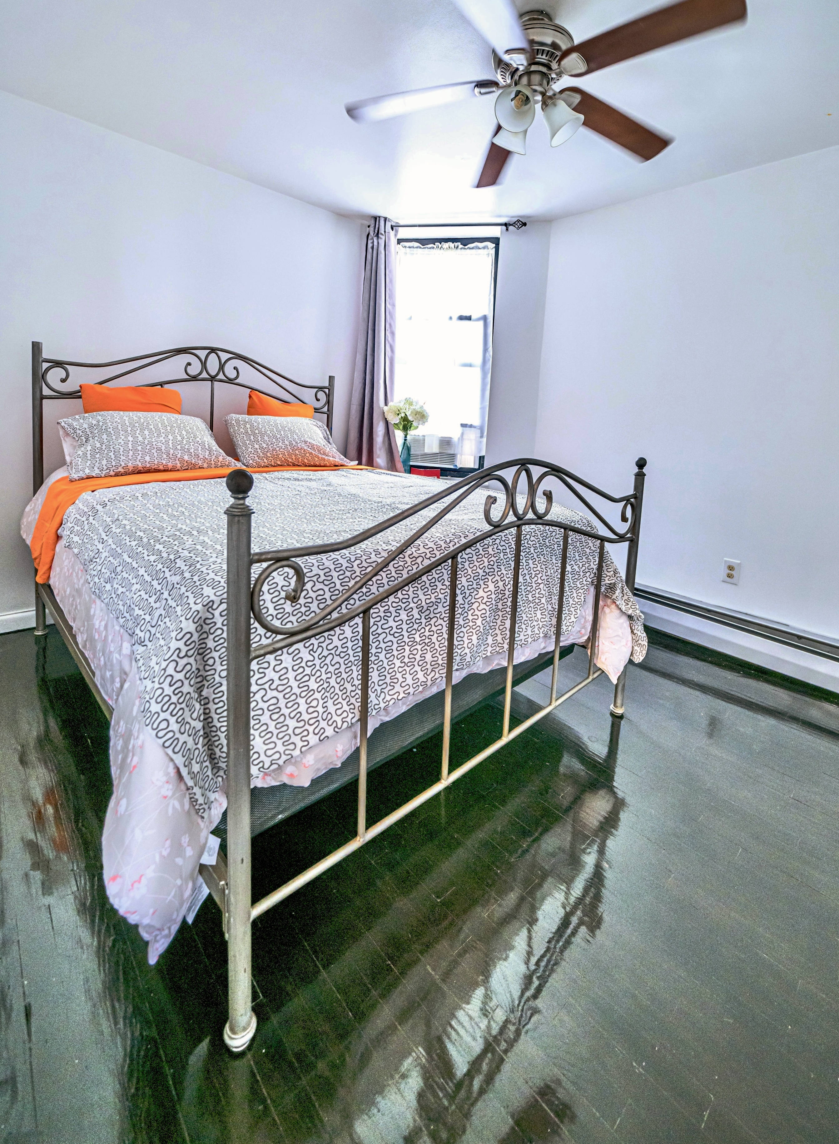 5 East 131st Street, Unit A3 Manhattan, NY 10037 - Photo 5 of 10 a bedroom with a bed and a chandelier