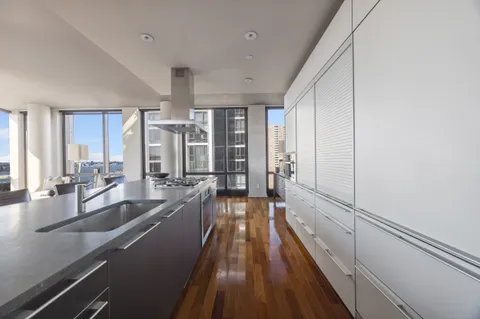 a view of a kitchen with a large window