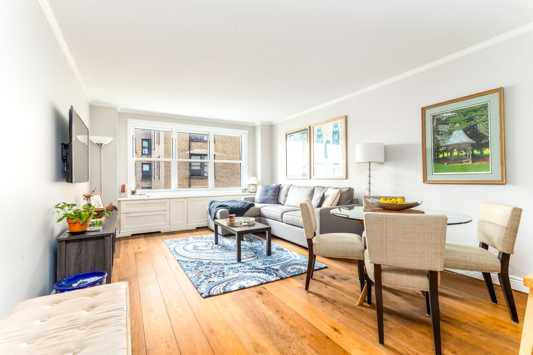 415 East 85th Street, Unit 5J Manhattan, NY 10028 - Photo 2 of 19 a living room with furniture and a flat screen tv