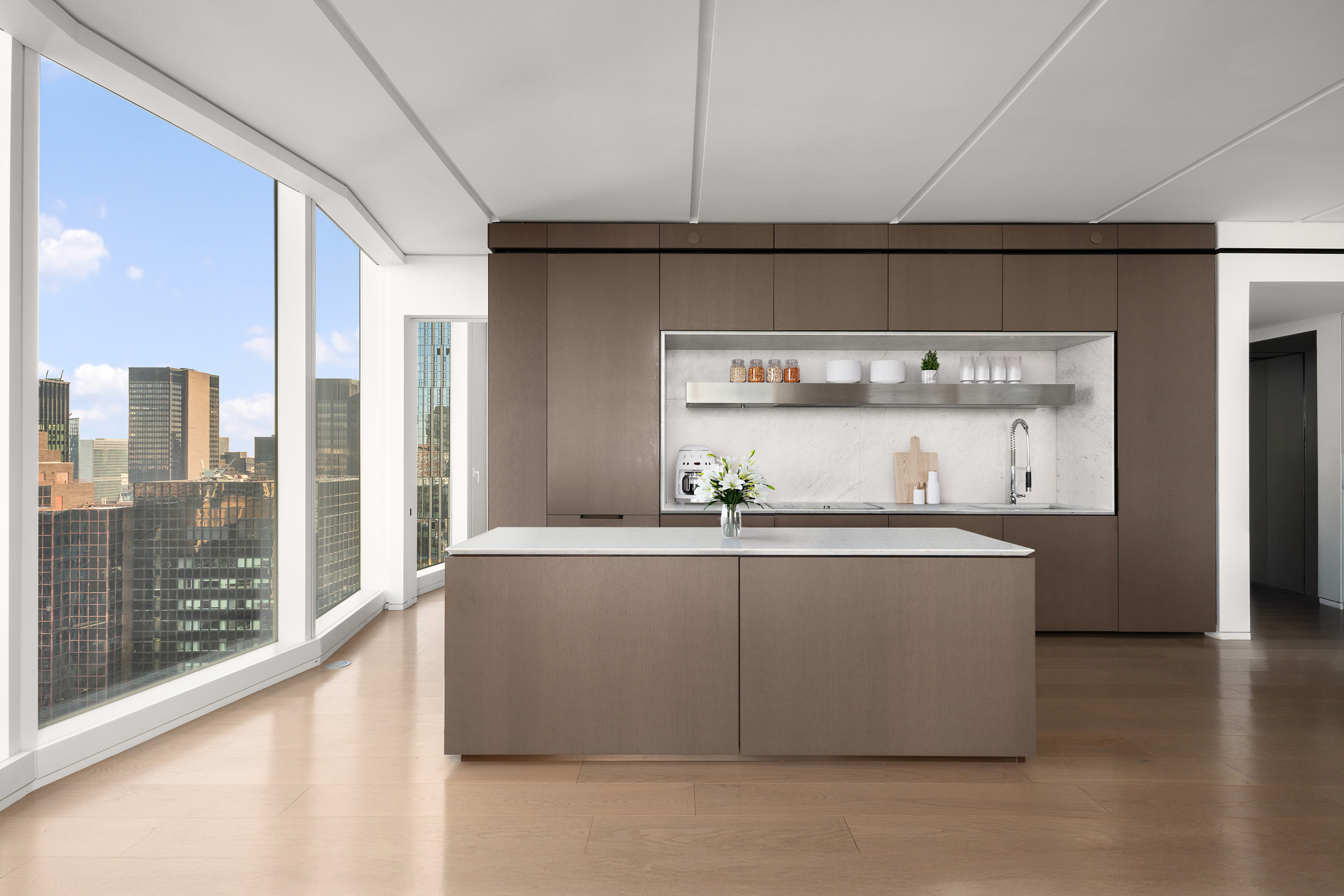 100 East 53rd Street, Unit 40A Manhattan, NY 10022 - Photo 3 of 20 a view of kitchen with stainless steel appliances granite countertop a sink and a refrigerator