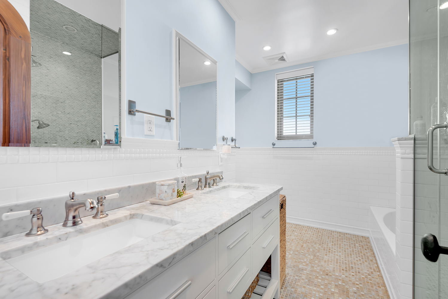 7921 Narrows Avenue Brooklyn, NY 11209 - Photo 24 of 42 a bathroom with double vanity sinks and a mirror