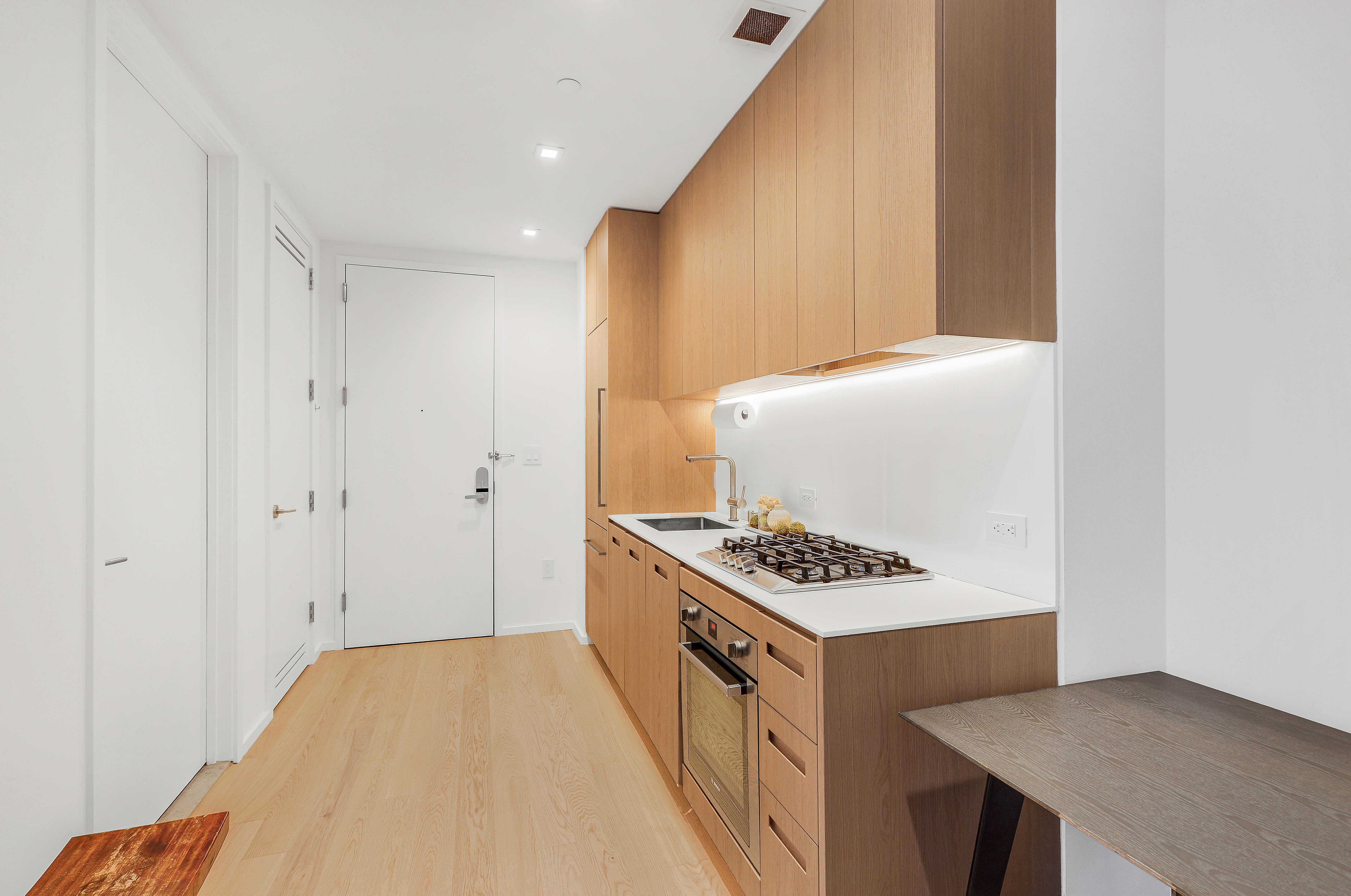 98 Front Street, Unit 9A Brooklyn, NY 11201 - Photo 7 of 31 a kitchen with stainless steel appliances a stove a sink and a refrigerator