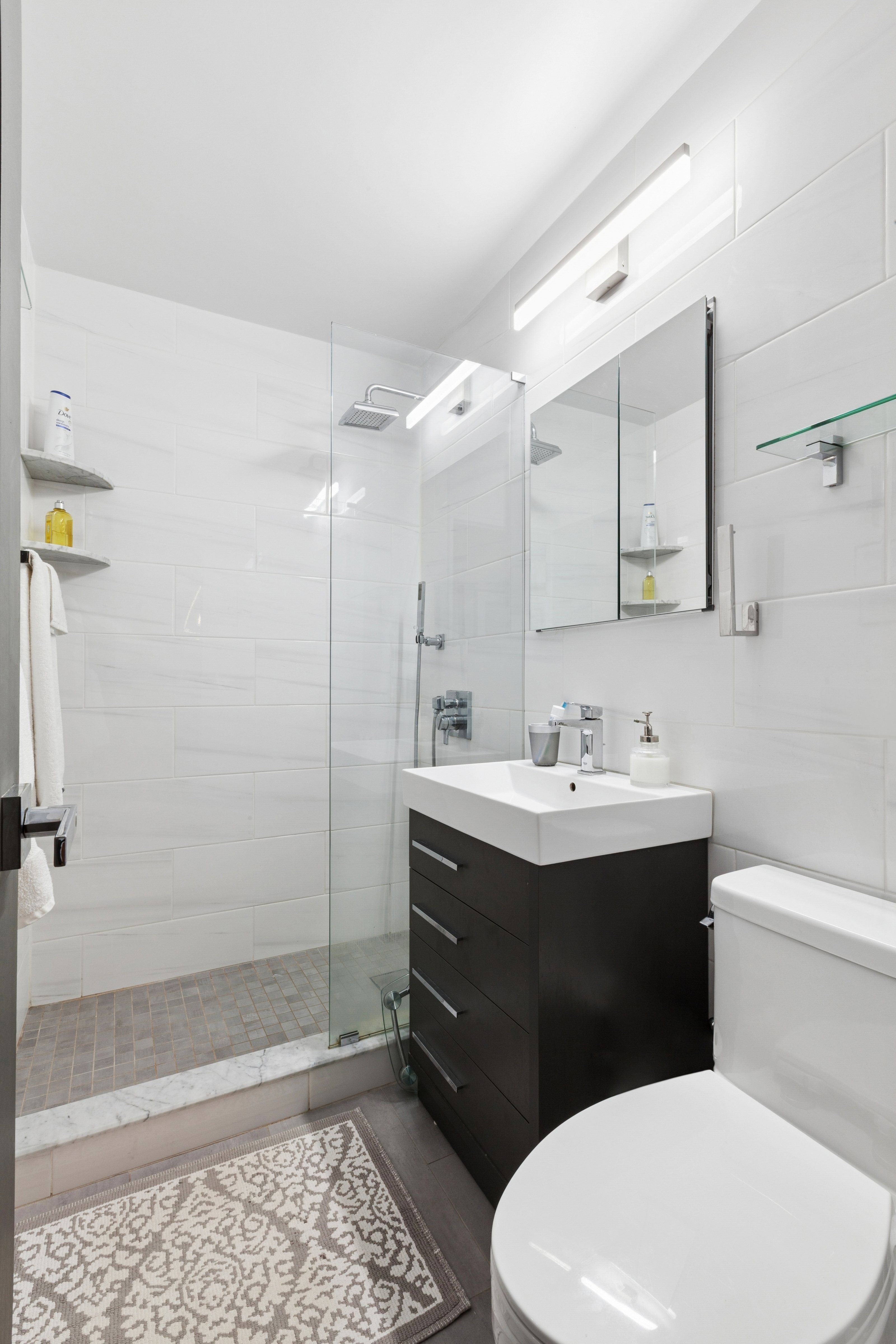 70-25 Yellowstone Boulevard, Unit 5Z Queens, NY 11375 - Photo 6 of 18 a bathroom with a sink a toilet and shower