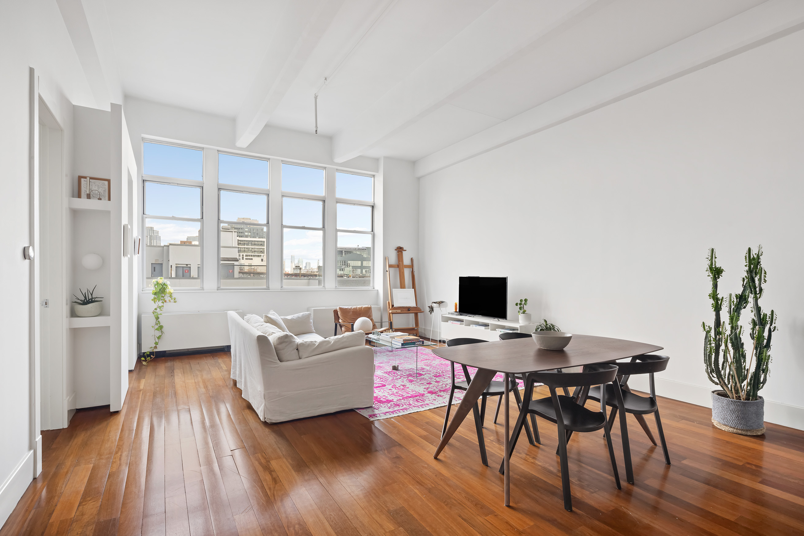 60 Broadway, Unit 6H Brooklyn, NY 11249 - Photo 2 of 16 a living room with furniture and a wooden floor