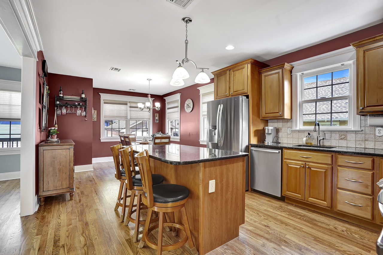 266 Feronia Way Rutherford, NJ 07070 - Photo 12 of 41 a kitchen with stainless steel appliances granite countertop a kitchen island hardwood floor sink stove dining table and chairs