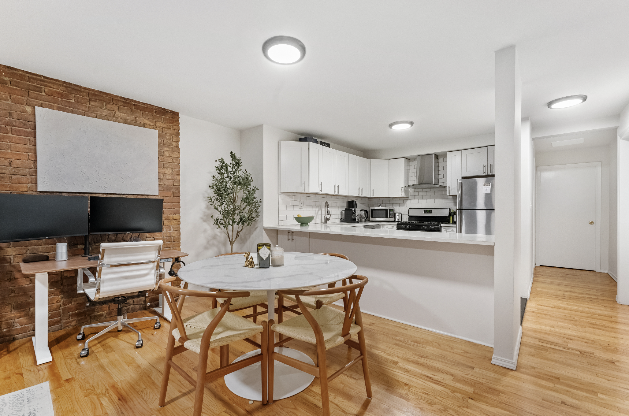 355 West 20th Street, Unit 1 Manhattan, NY 10011 - Photo 3 of 9 a kitchen with a table and chairs in it