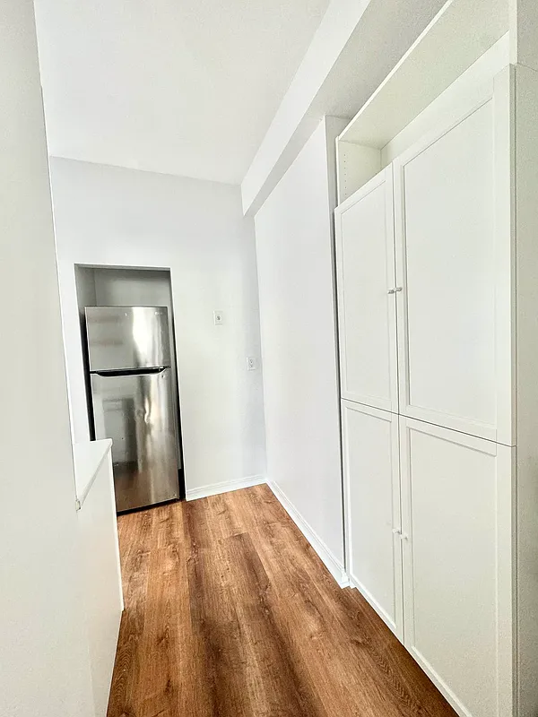 2022 Beverley Road, Unit 3 Brooklyn, NY 11226 - Photo 11 of 11 a view of a hallway with wooden floor and a bathroom