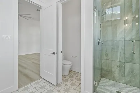 a bath room with a toilet and a bath tub