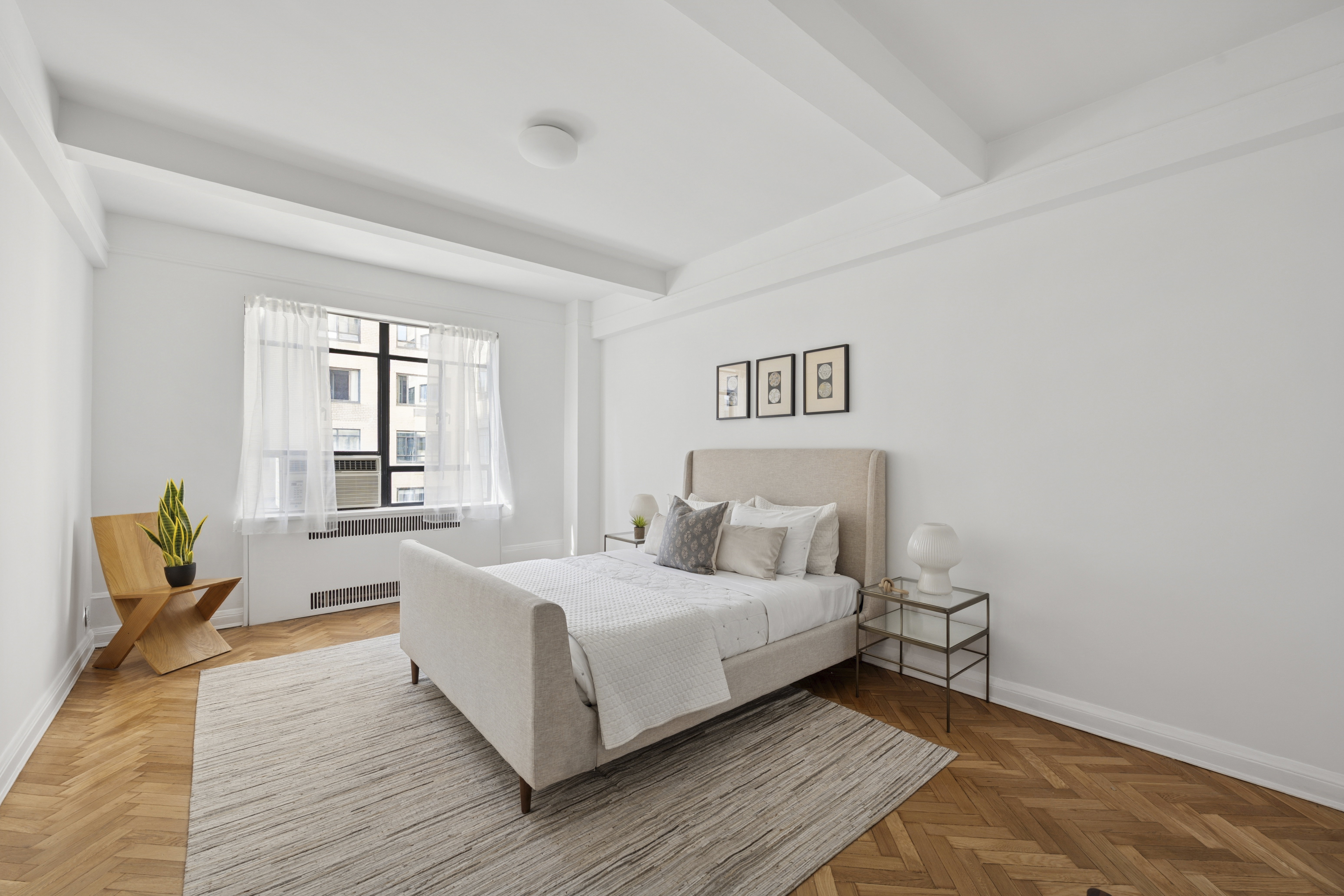 140 Riverside Drive, Unit 10N Manhattan, NY 10024 - Photo 11 of 21 a bedroom with a bed and wooden floor