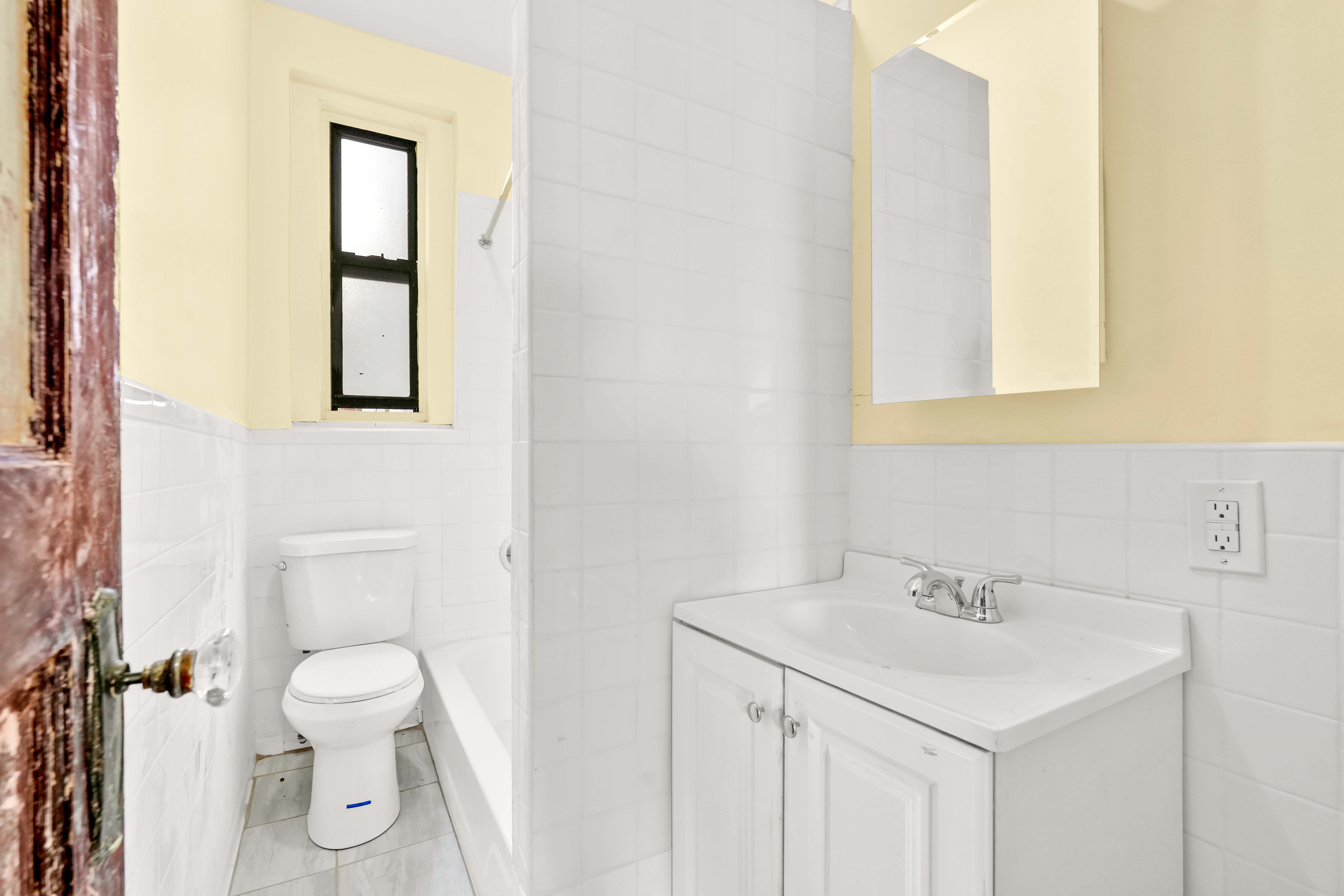 1770 Bedford Avenue Brooklyn, NY 11225 - Photo 17 of 50 a bathroom with a toilet sink and mirror