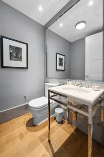 a bathroom with a toilet a sink and mirror