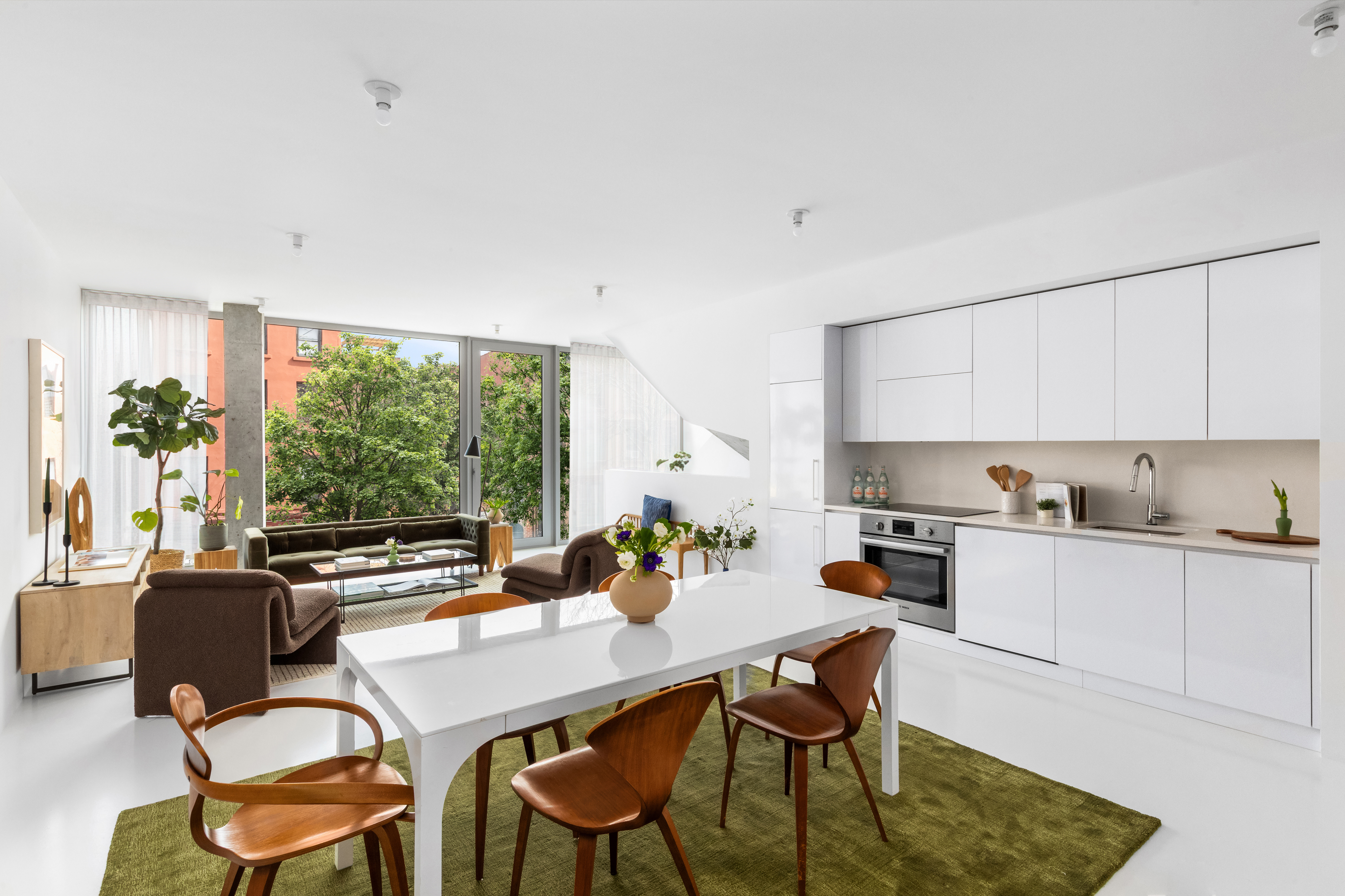 272 Greene Avenue Brooklyn, NY 11238 - Photo 2 of 19 a kitchen with a table chairs stove and cabinets