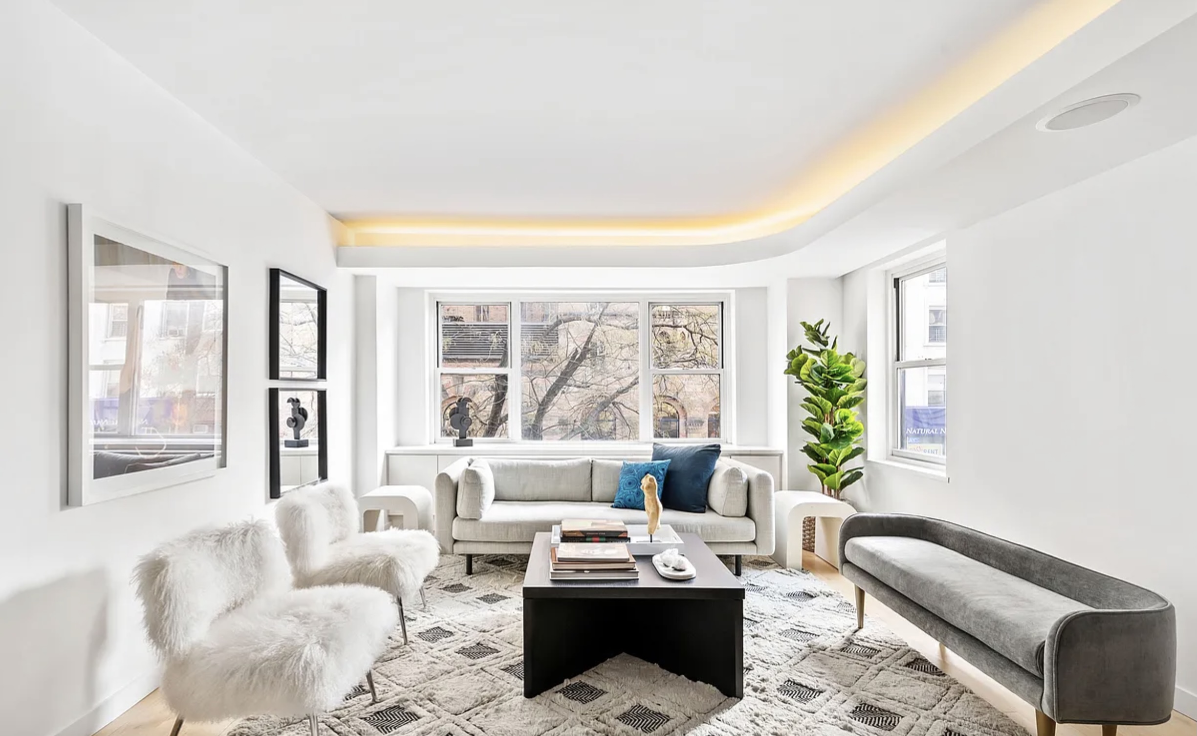 130 East 63rd Street, Unit 3D Manhattan, NY 10065 - Photo 2 of 13 a living room with furniture and a large window