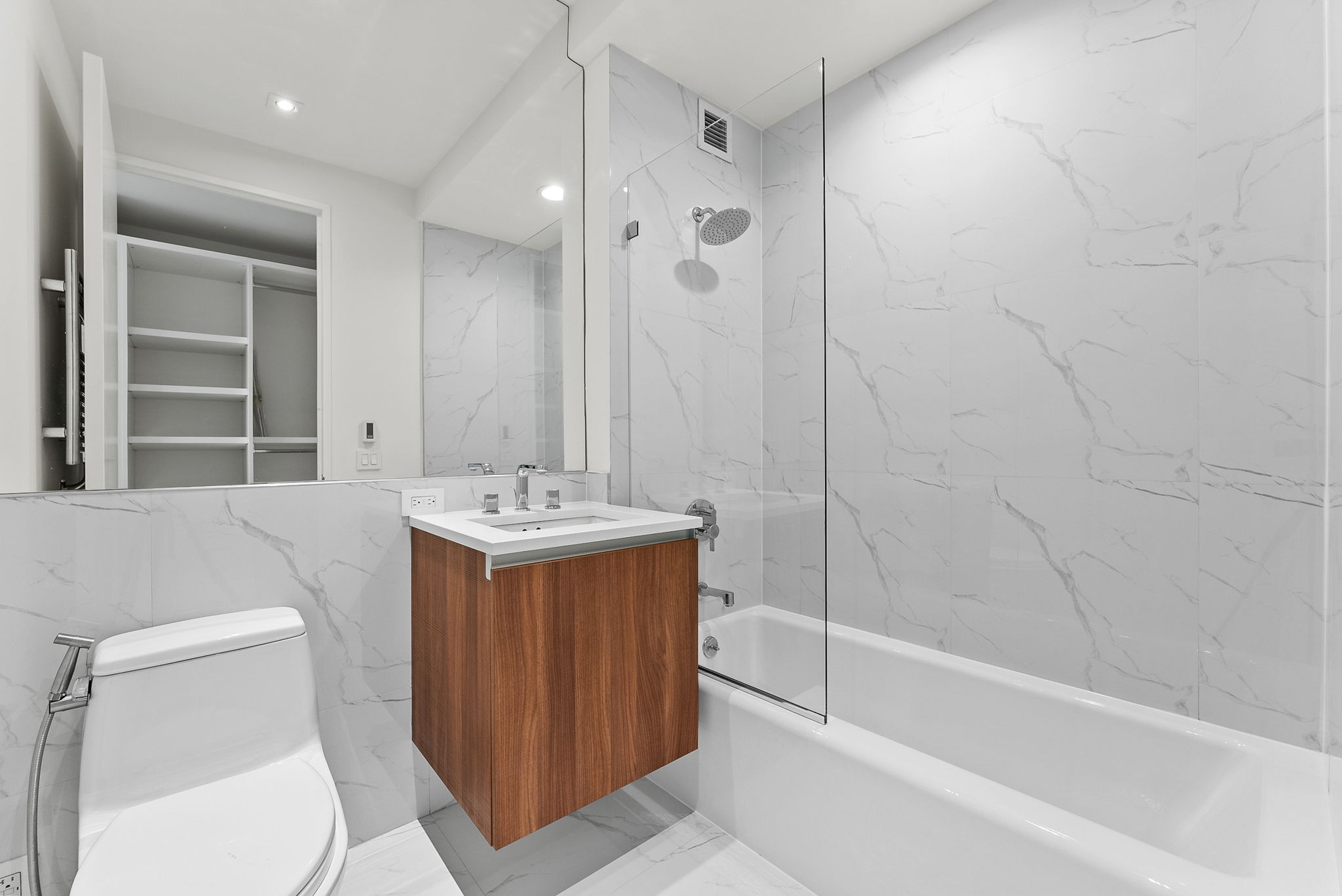 845 United Nations Plaza, Unit 63D Manhattan, NY 10017 - Photo 9 of 16 a bathroom with a sink a toilet and shower