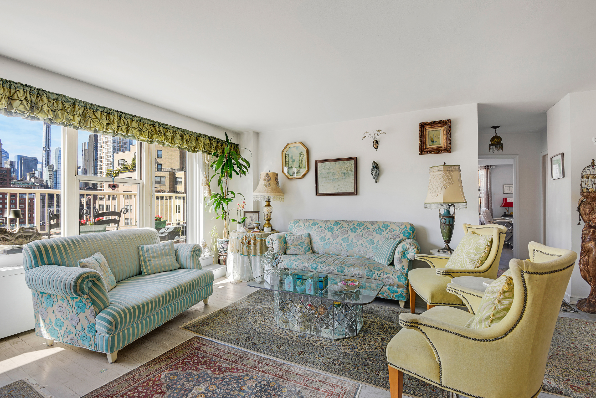 305 East 24th Street, Unit 18C Manhattan, NY 10010 - Photo 2 of 13 a living room with furniture and a large window