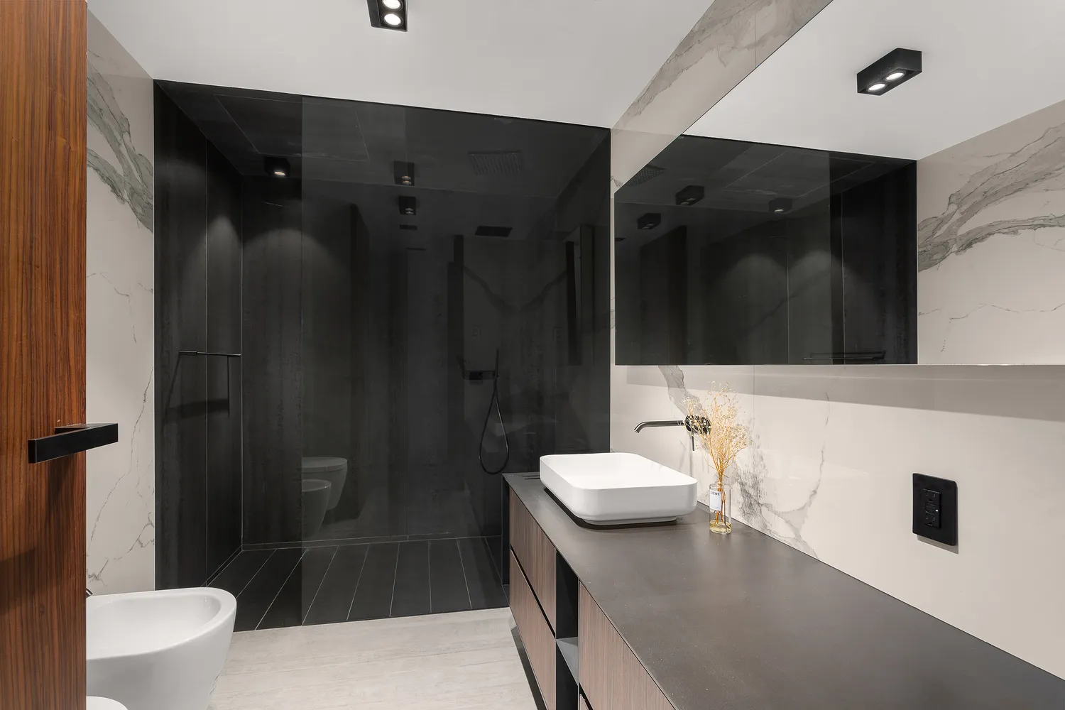 a bathroom with a sink a toilet and shower