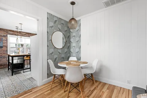 a view of a dining room with furniture and wooden floor