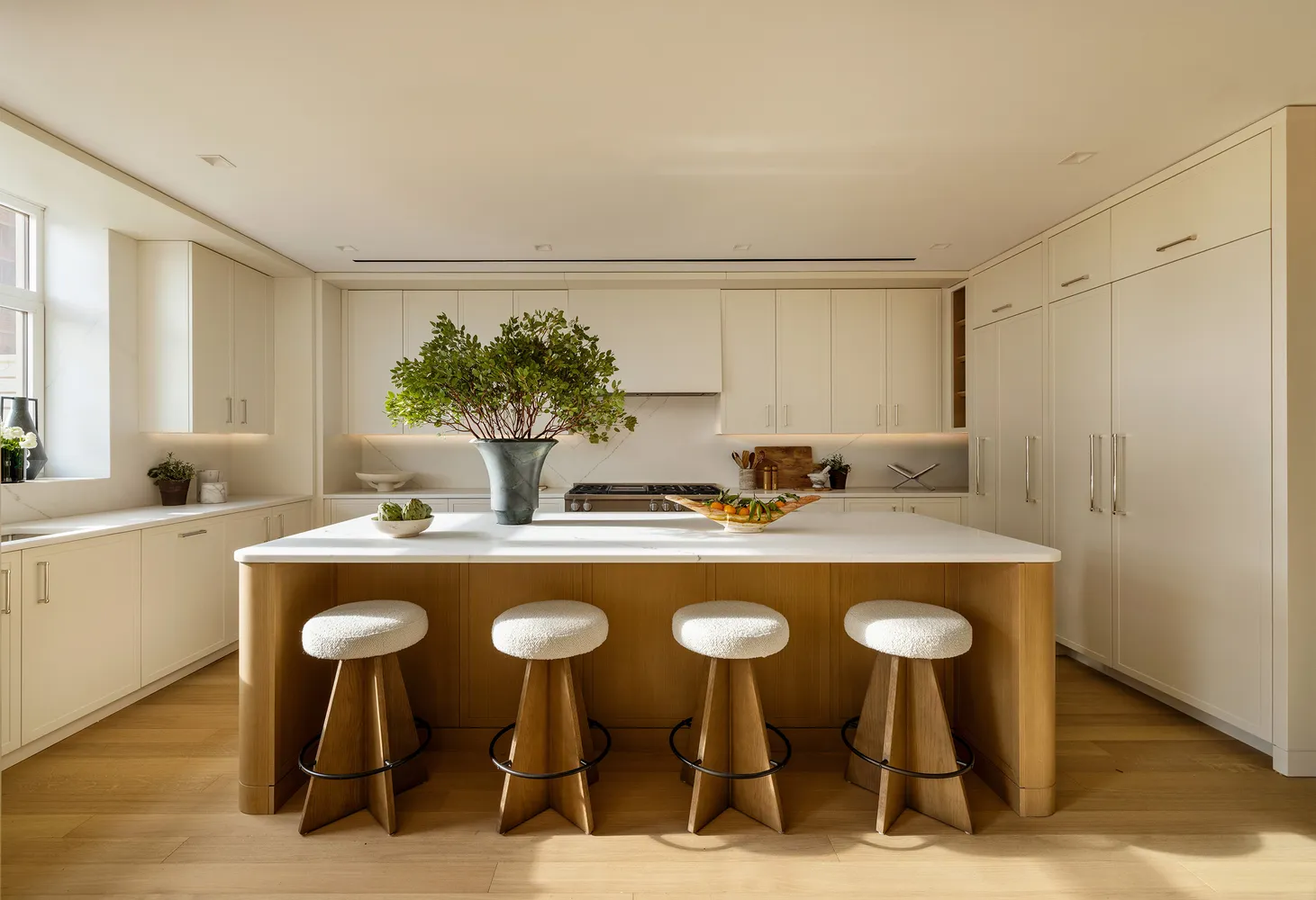 a kitchen with sink and chairs