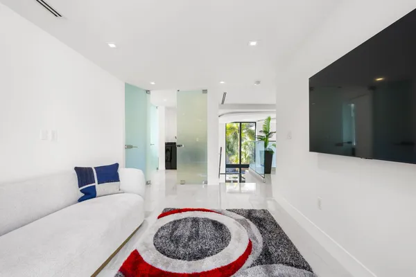 a spacious bedroom with a large bed and a large window