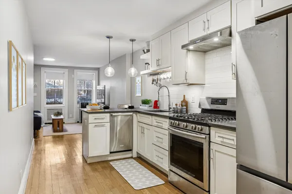 a kitchen with a stove a sink and a refrigerator
