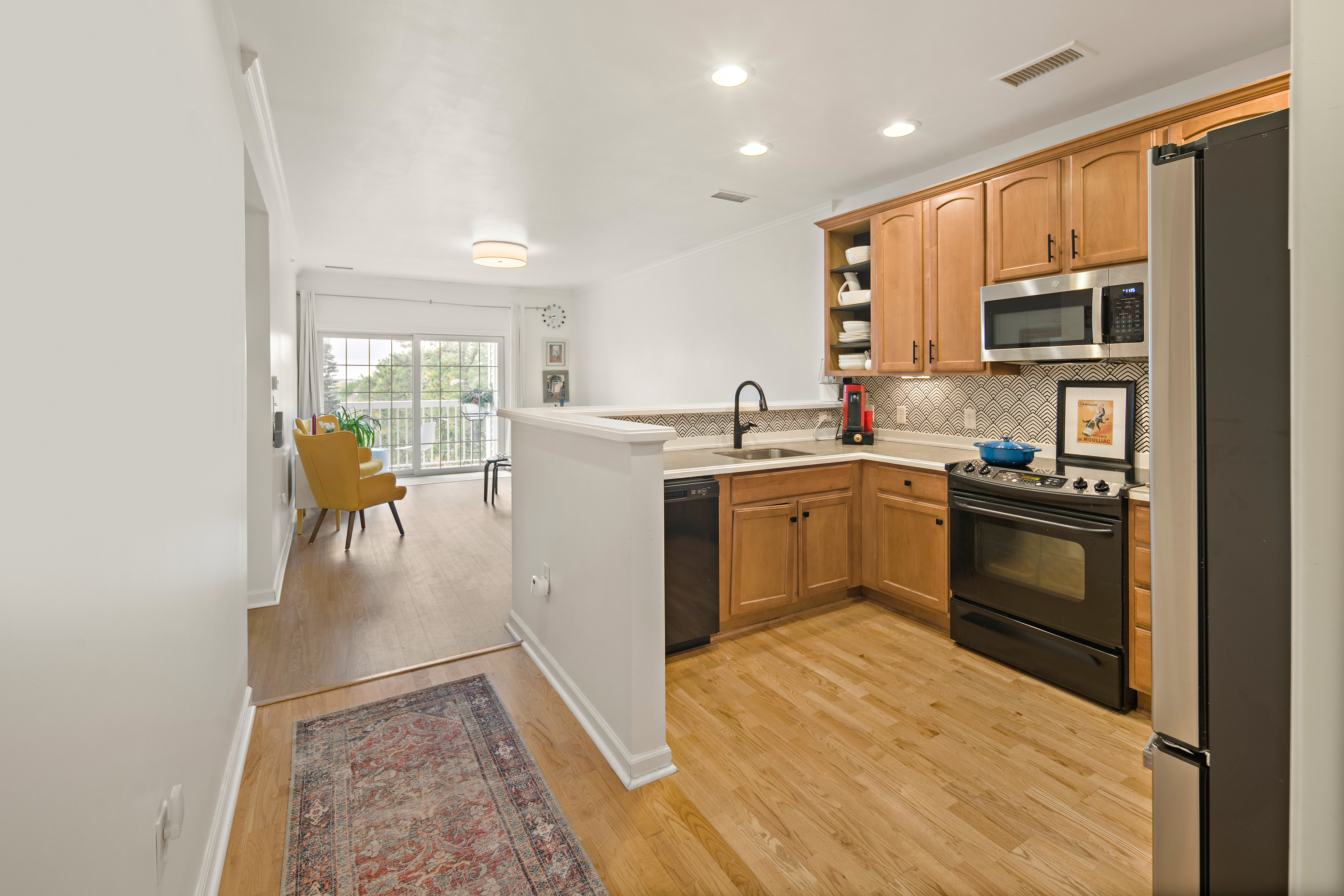 107 Clocktower Drive, Unit 407 Waltham, MA 02452 - Photo 2 of 19 a kitchen with a sink appliances and cabinets