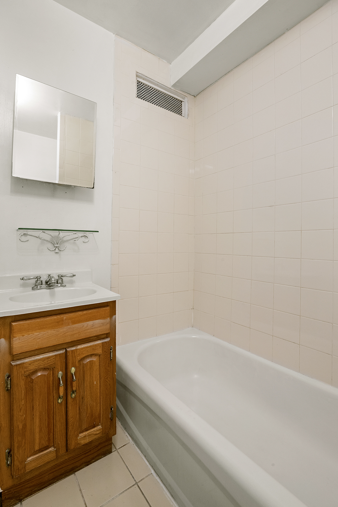1437 Lincoln Place Brooklyn, NY 11213 - Photo 10 of 12 a bathroom with a bathtub and a sink