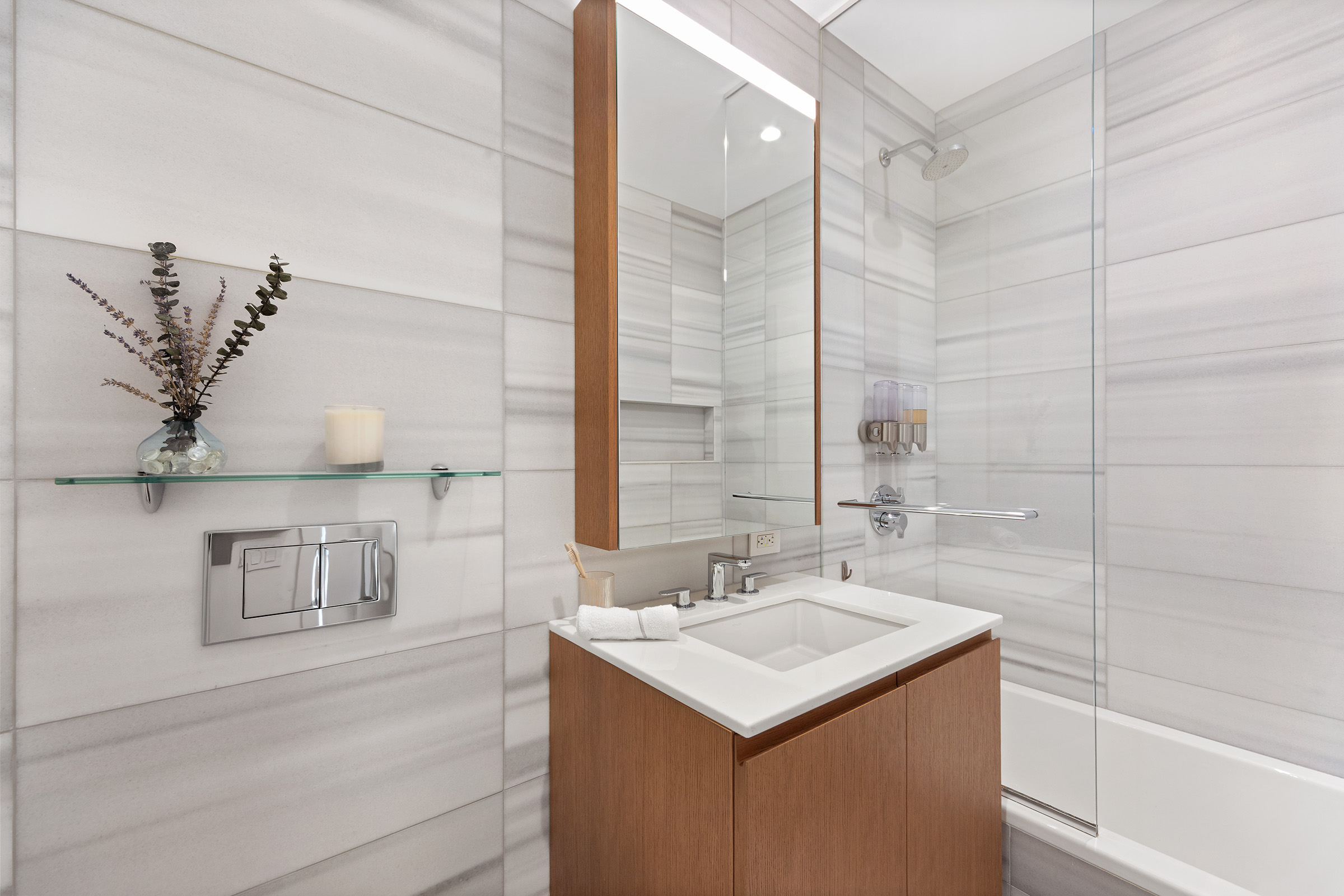 50 West Street, Unit 37C Manhattan, NY 10006 - Photo 23 of 43 a bathroom with a sink and a mirror