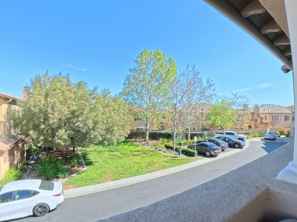 a view of a garden with a building in the background