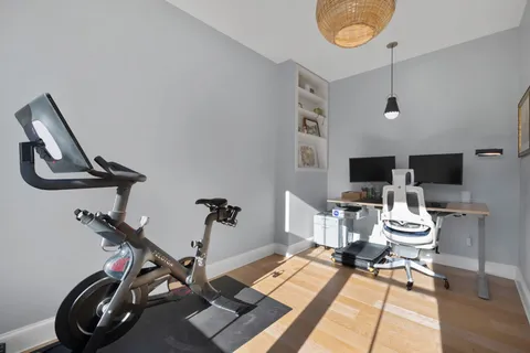 a view of a workspace with furniture and a flat screen tv