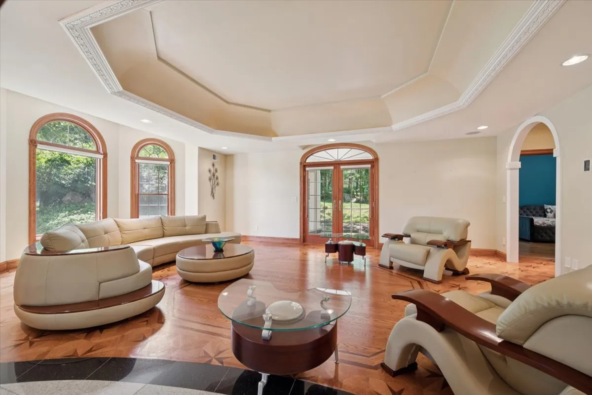 a living room with furniture and chandelier