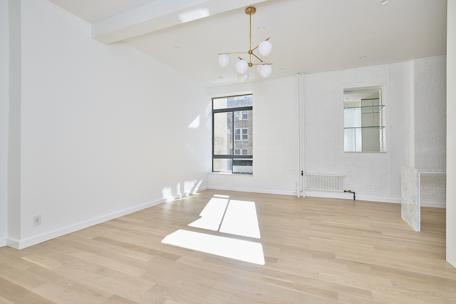 23 East 10th Street, Unit 508 Manhattan, NY 10003 - Photo 12 of 21 a view of empty room with wooden floor and window