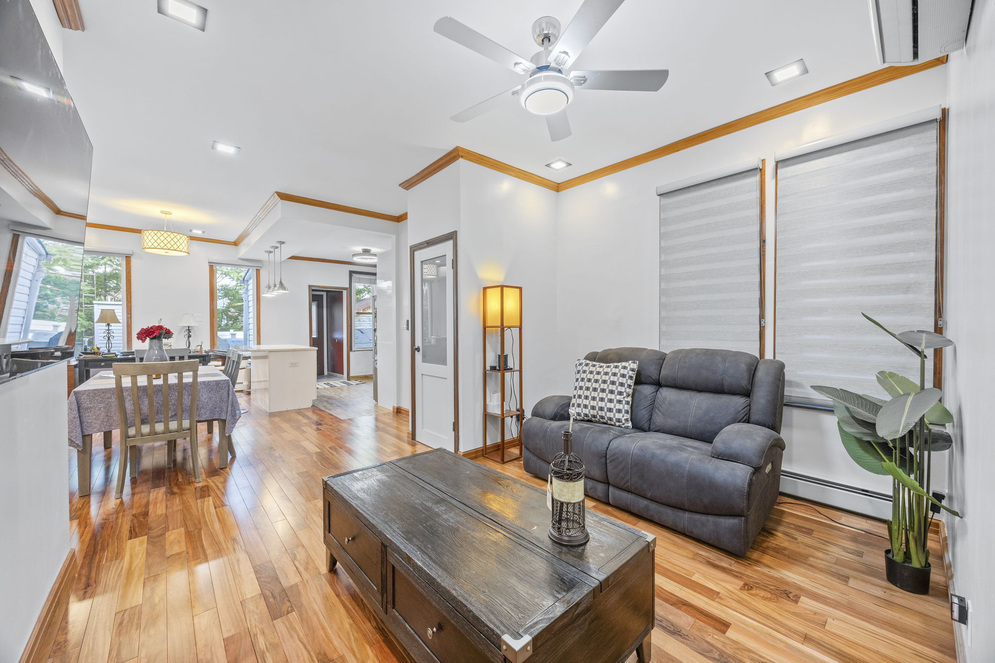 25-69 46th Street Queens, NY 11103 - Photo 16 of 33 a living room with furniture and wooden floor